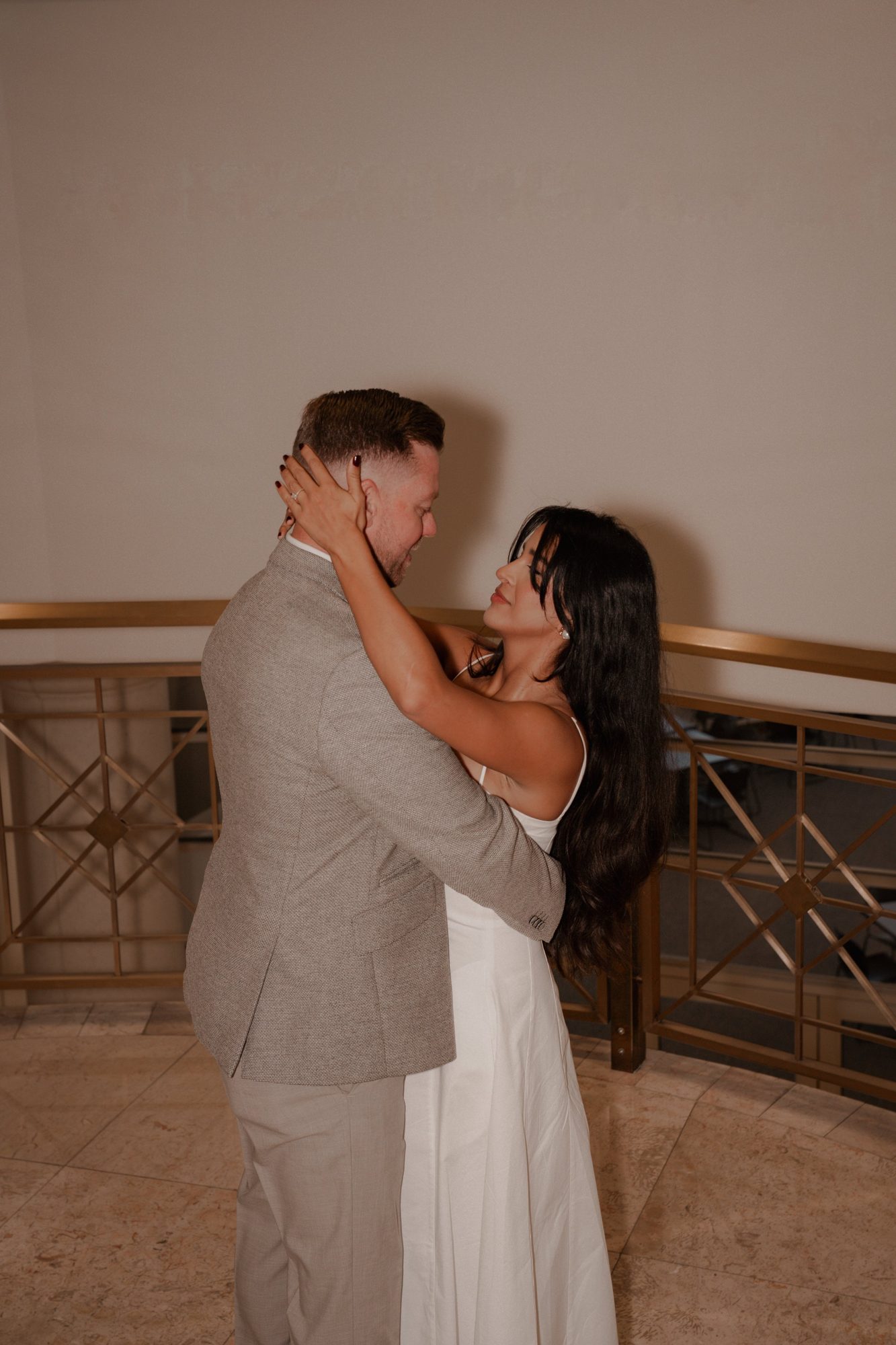Couple on an ornate staircase looking at each other