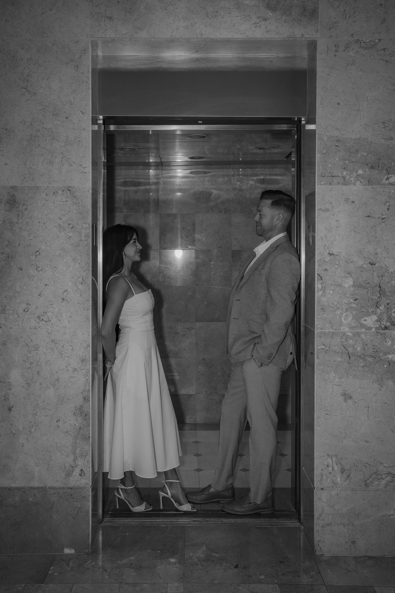Black and white portrait of a couple inside an elevator