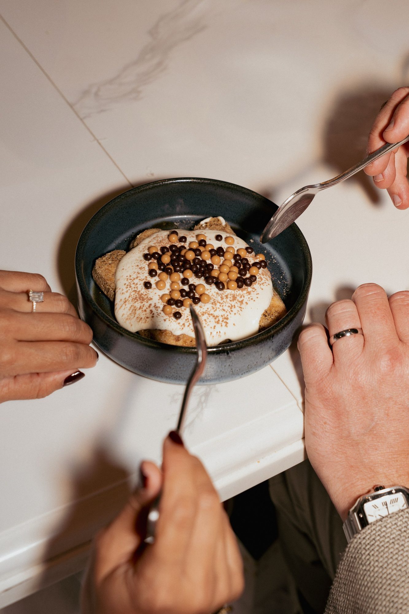 Overhead view of a couple sharing dessert during their reception