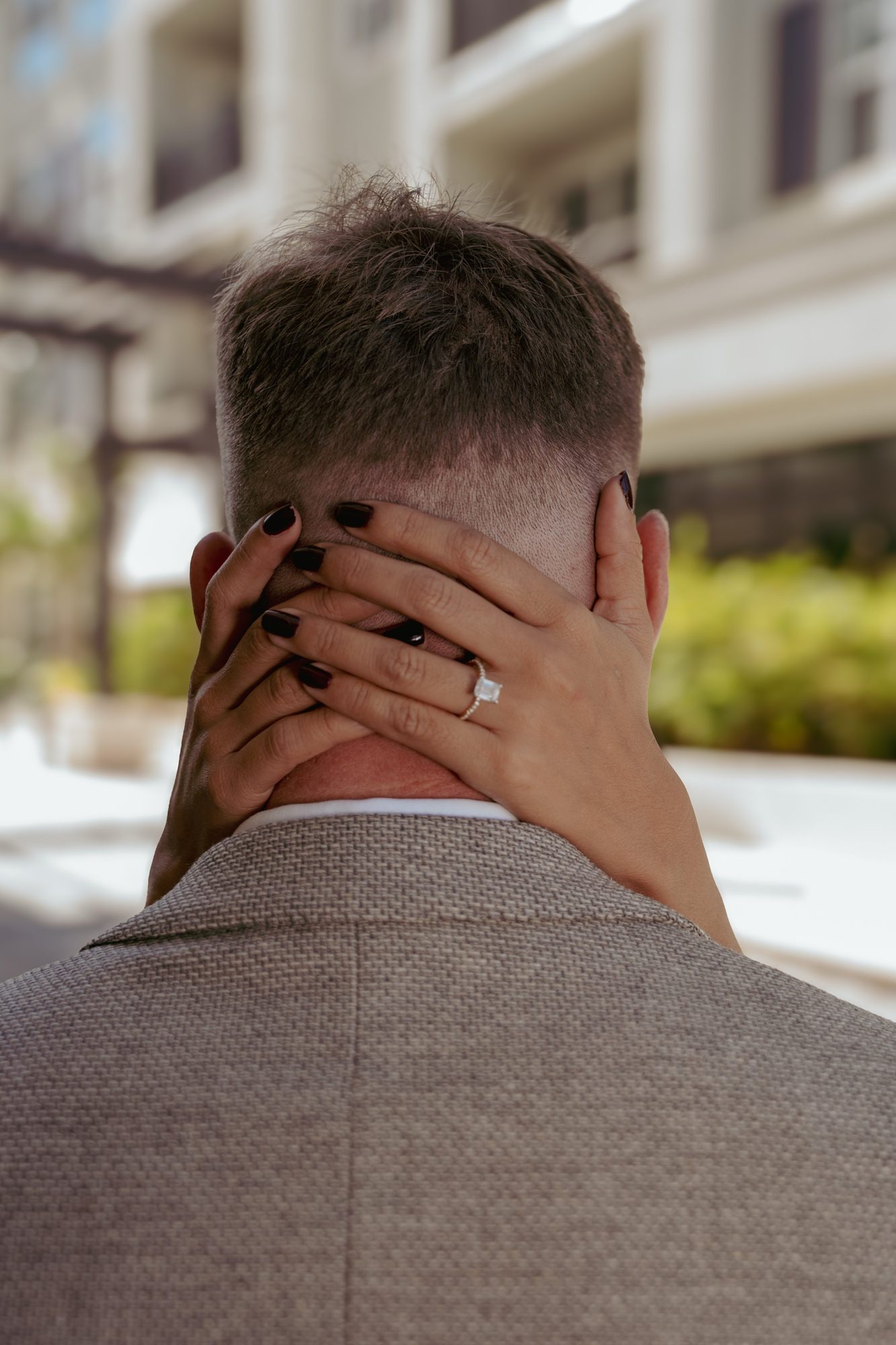 Bride holding the groom close during a quiet portrait moment