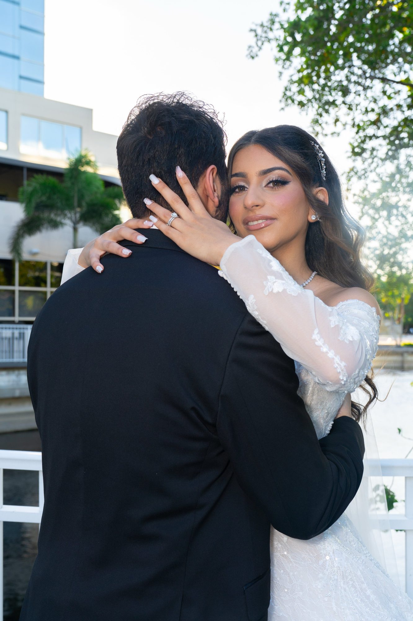 Couple embracing near the water at golden hour
