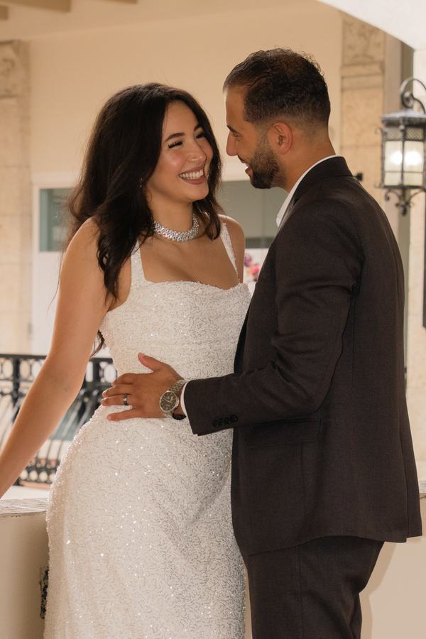 A quiet, tender embrace between a bride and groom