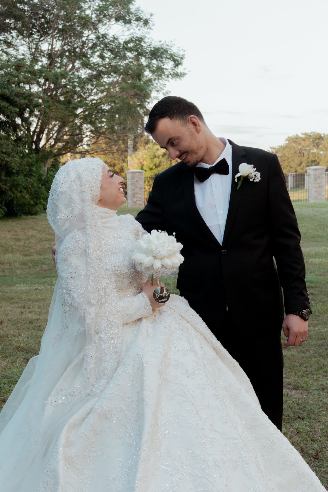 Bride and groom with foreheads together in a quiet garden moment